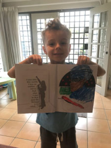 hoto of Lucas holding his page up
